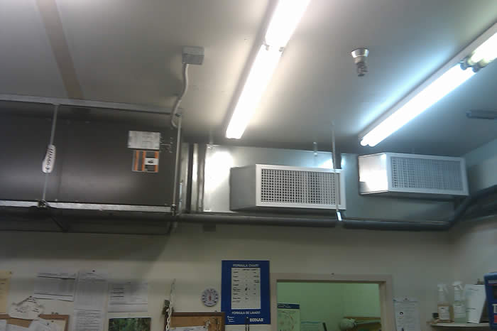 Simple commercial laundry cooling system, horizontal installation with exposed ductwork.